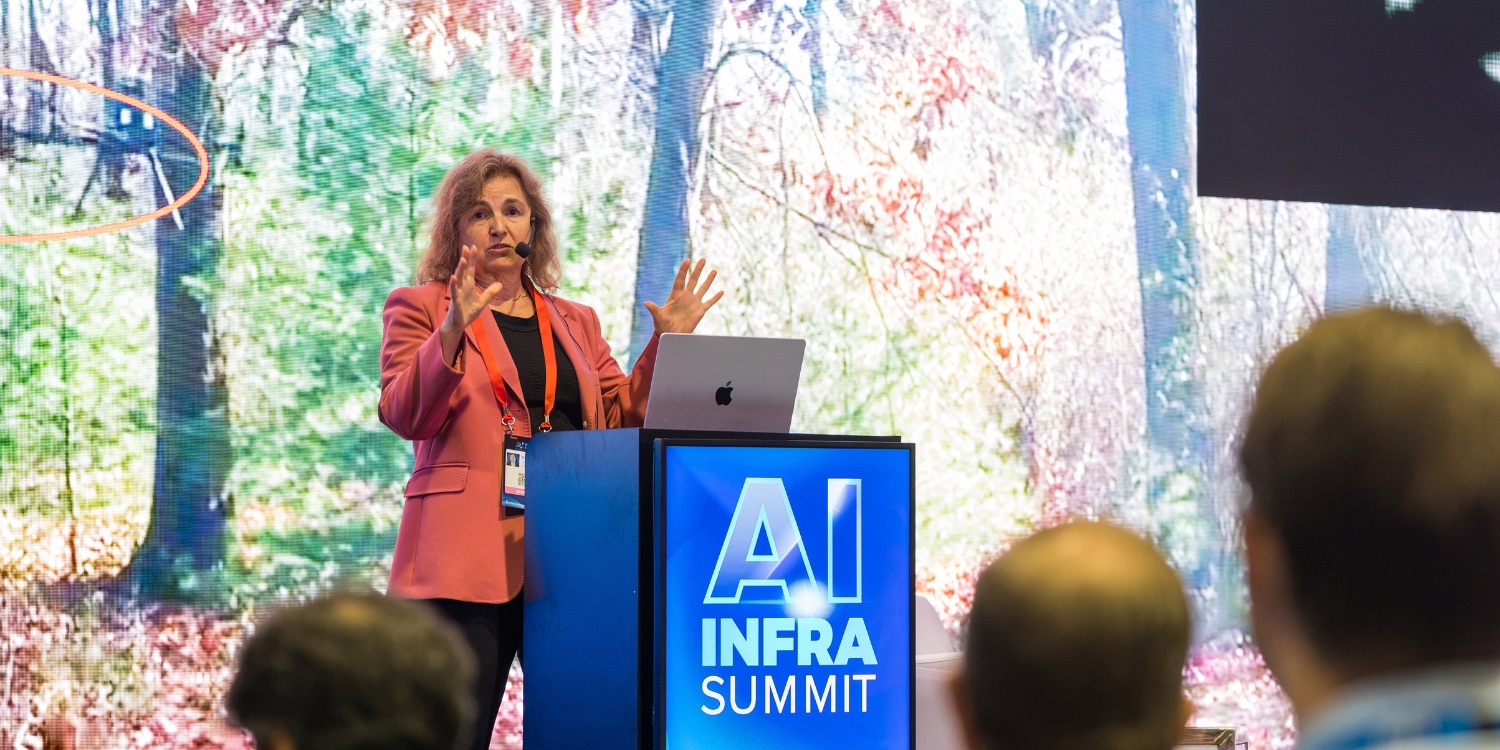 A speaker presenting on the AI Infra Summit 2026 stage in Santa Clara
